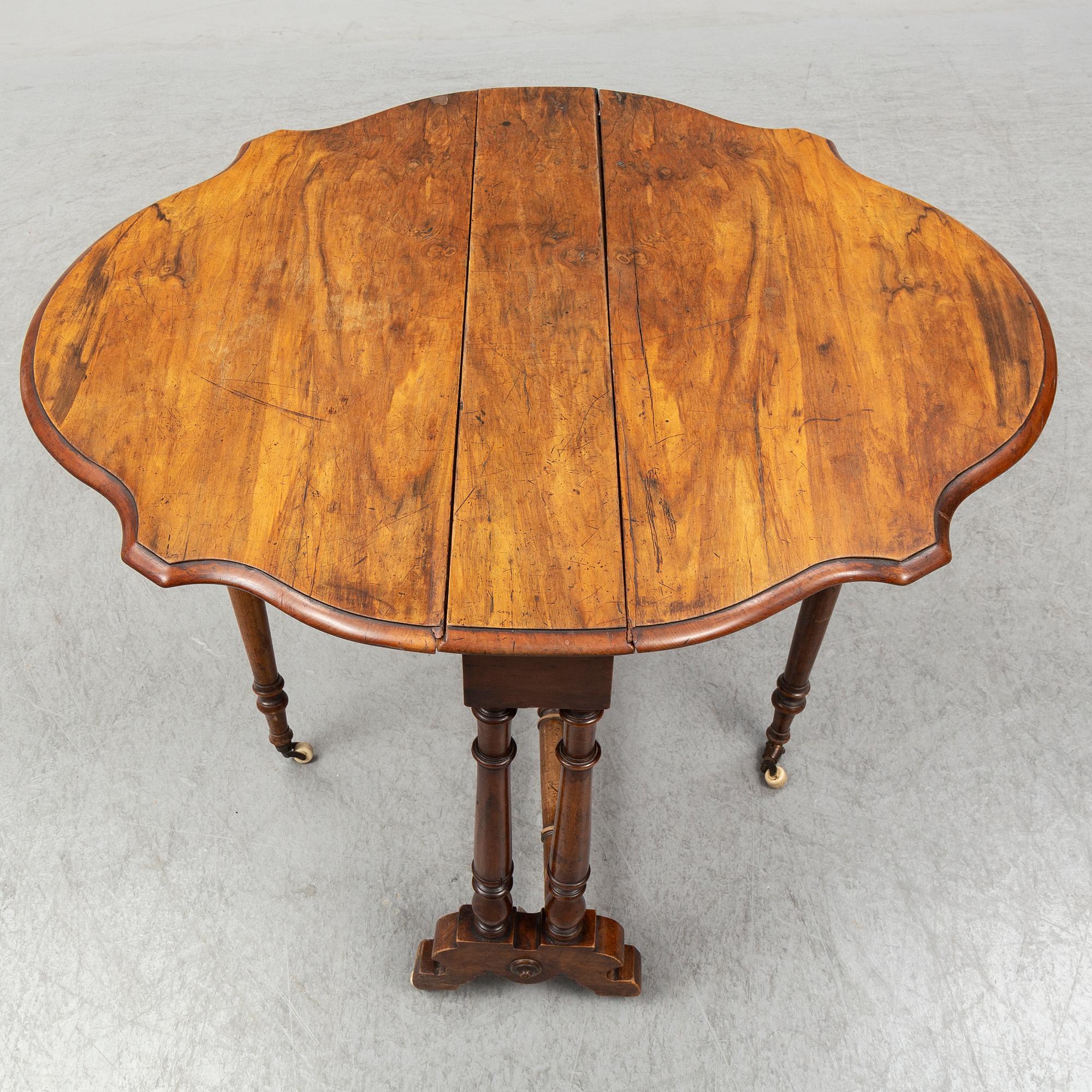 A 19th Century drop leaf table.