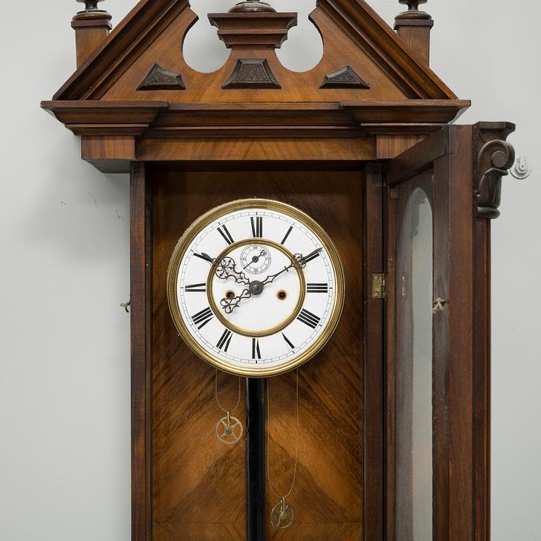 A late 19th century wall pendulum clock.