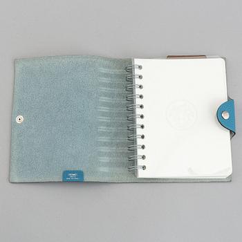 Hermès, a blue leather notebook with two scripple pads.