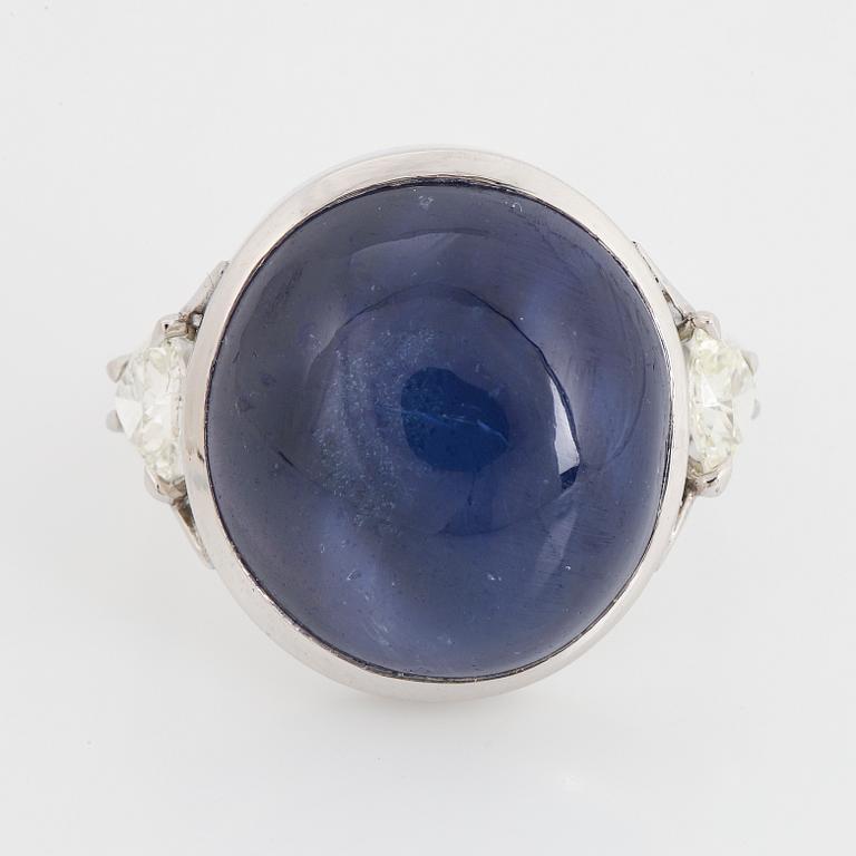 Cabochon-cut sapphire and triangle shaped diamond ring.