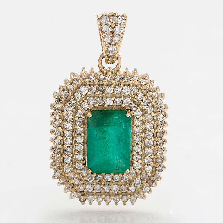 A 14K gold pendant with emerald and brilliant cut diamonds totaling approx. 0.95 ct.