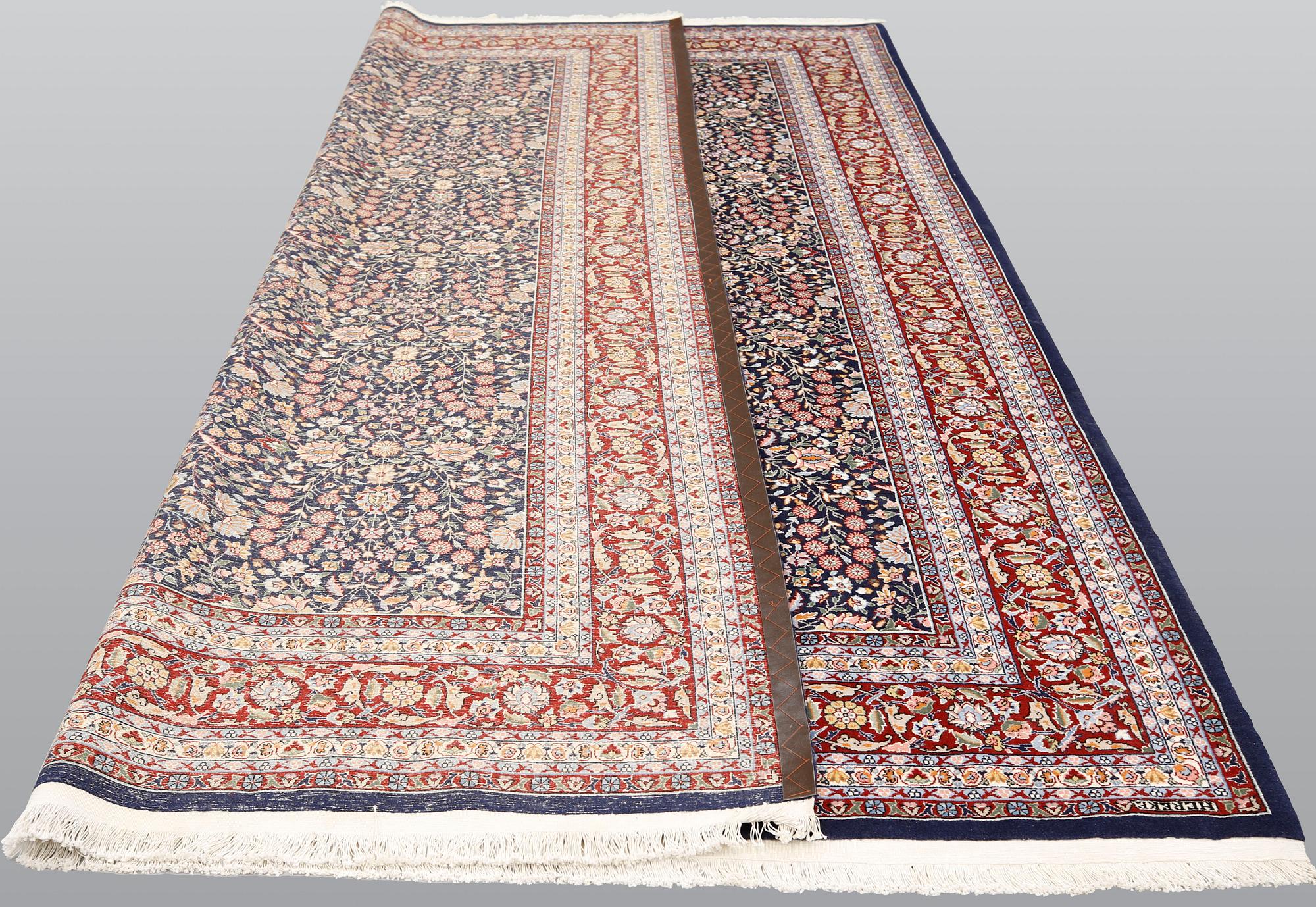 A signed Hereke carpet, ca 340 x 246 cm.