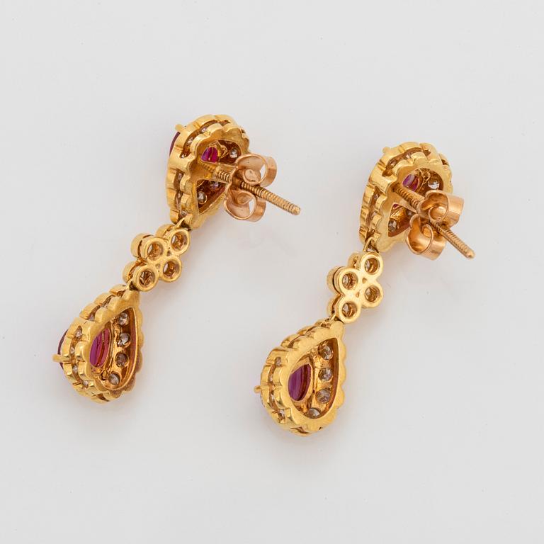 A pair of 18K gold earrings set with faceted rubies and round brilliant-cut diamonds.