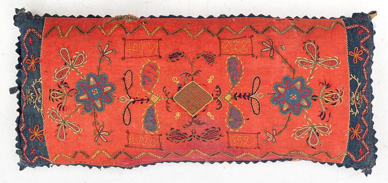 An embroidered carriage cushion, 100 x 50 cm, dated 1852.