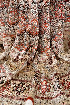 An Oriental silk rug, diameter 256 cm.