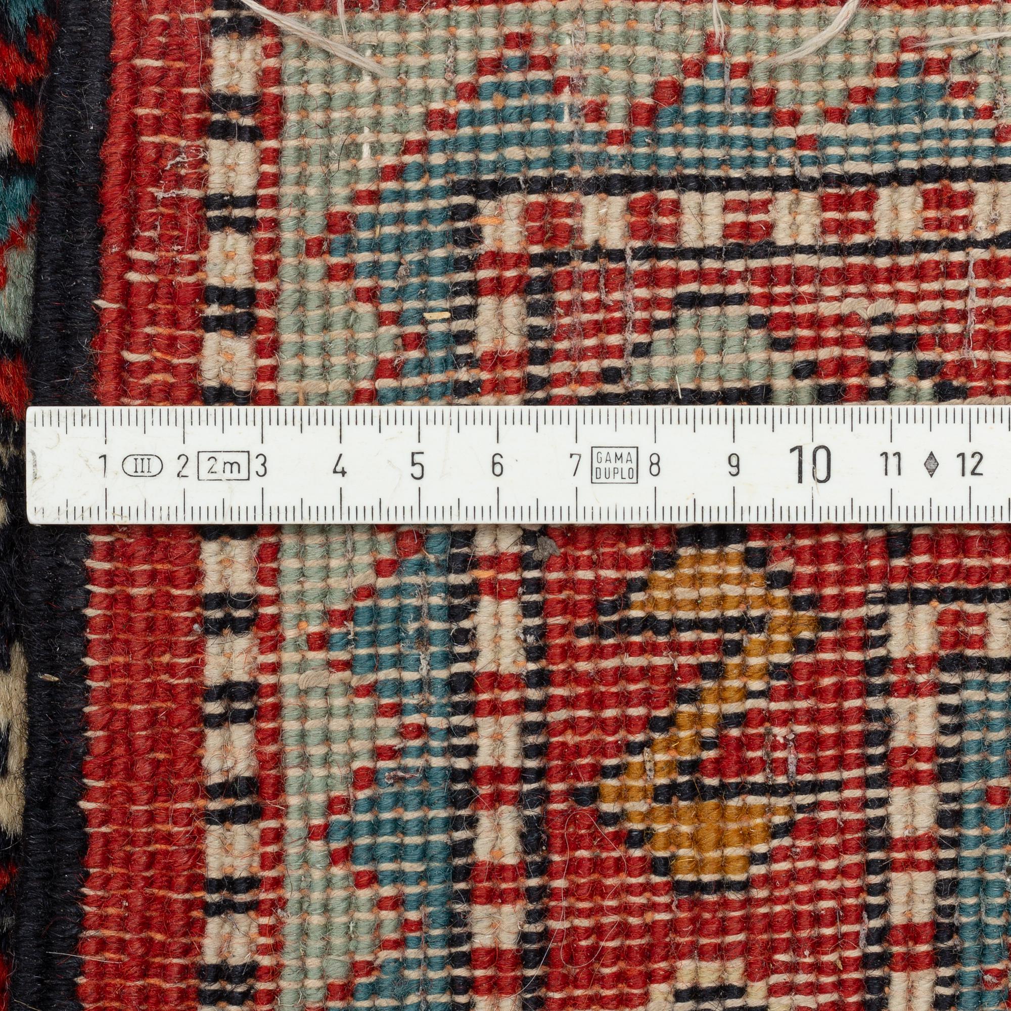 An oriental runner, c. 355 x 75 cm.