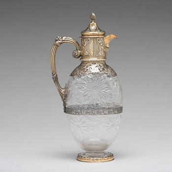 An English 19th century silver-gilt and glass wine-jug, marked Hunt & Roskell Late Storr & Mortimer, London 1895.