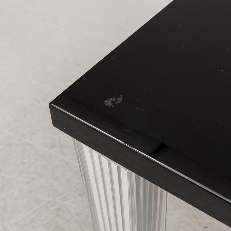 A "Tip Top" dining table by Philippe Starck for Kartell.