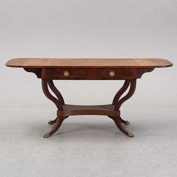 An Empire style mahogany  center table from around the year 1900.