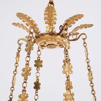 An Empire cut glass and gilded bronze six-light hanging lamp in the manner of Alexandre Guérin.