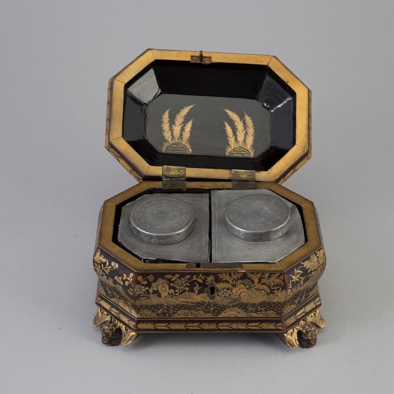 A Chinese lacquered box with cover with two pewter tea caddies, Qing dynasty, 19th Century.