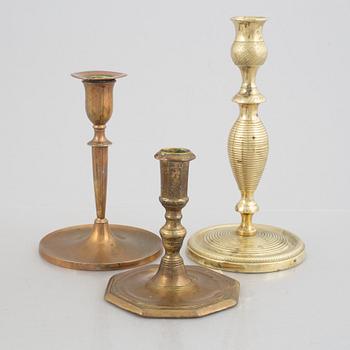 A set of five brass candlesticks, 18th / 19th Century.