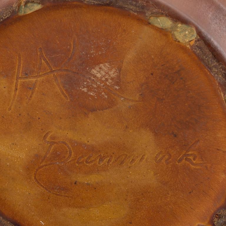 An earthenware pot decorated with four bulls heads. Probably by Karl Hansen Reistrup for Herman Kähler. Around 1900.