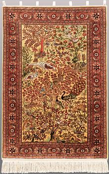 An Oriental figural silk rug, ca 126 x 83 cm.