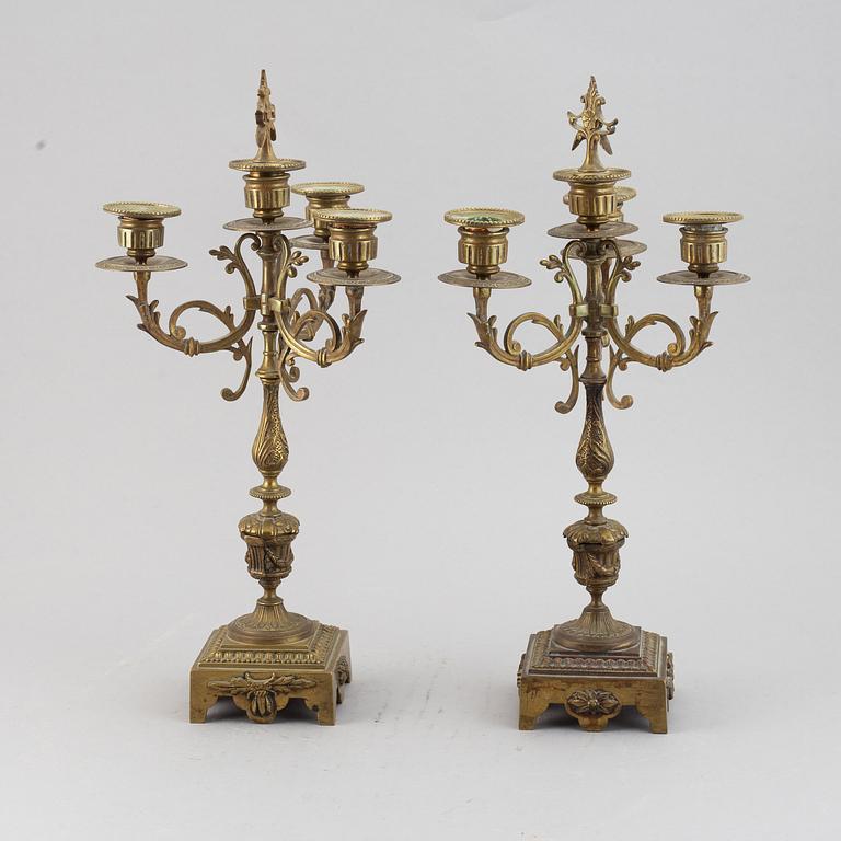 A mantle clock with pair of candelabra, late 19th century.