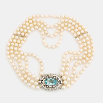 340. A four strand cultured pearl necklace with a clasp in 14K gold set with a faceted aquamarine.