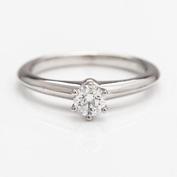 Tiffany & Co, A platinum ring with a ca. 0.26 ct diamond.