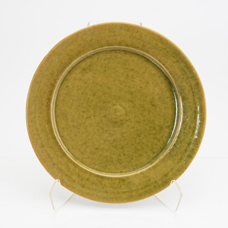 Signe Persson-Melin, a set of nine 1950s kopper glazed stoneware plates.