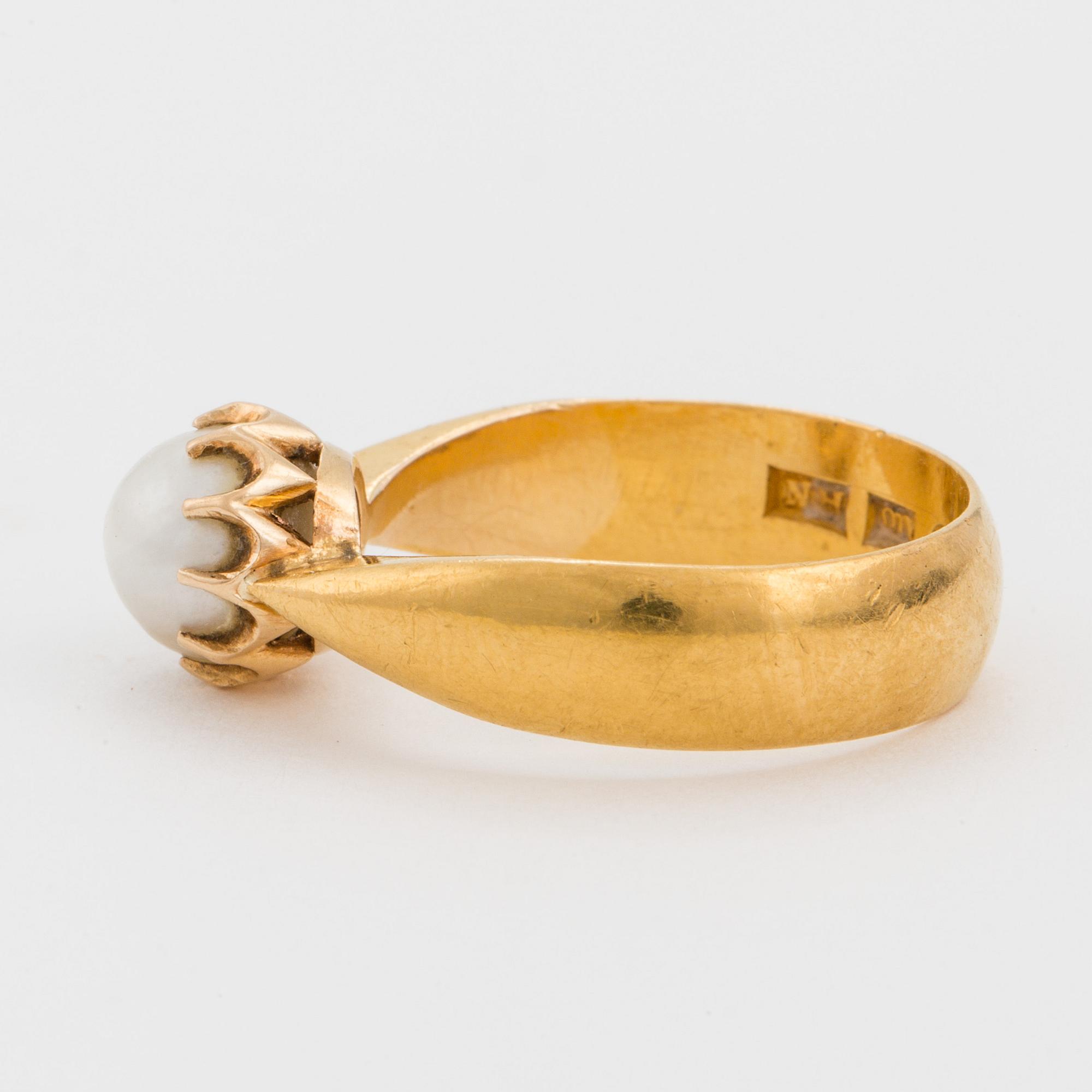 A ring set with a cultured, mabé pearl.