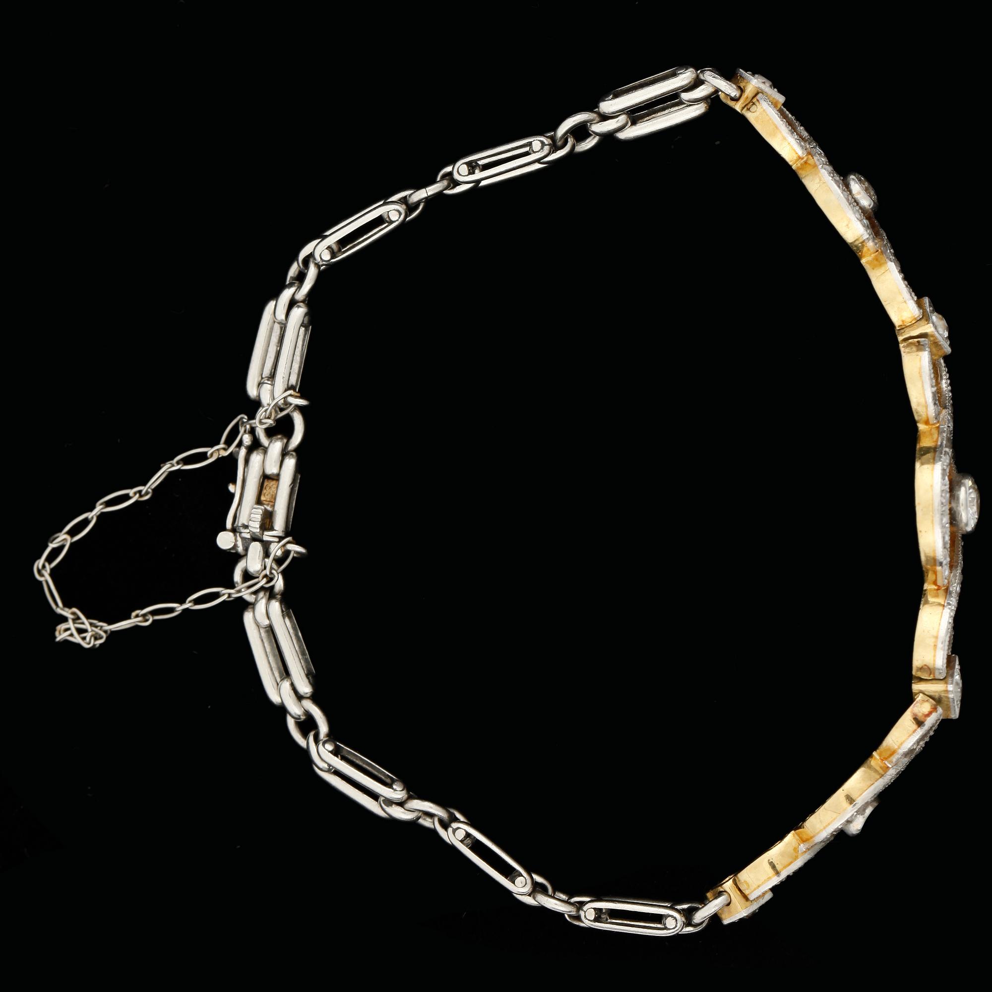 ARMBAND, 14k tvåfärgad med gammalslipade diamanter tot ca0,60ct samt rosenstenar. Tidigt 1900-tal. Vikt ca15,7g.