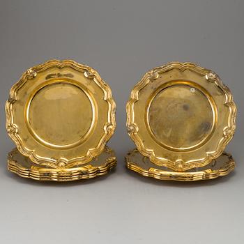 A German set of twelve 19th century silver-gilt plates, mark of Hossauer, Berlin. Rokoko-style.