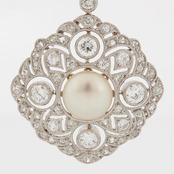 A platinum pendant set with a bouton pearl and old- and rose-cut diamonds.