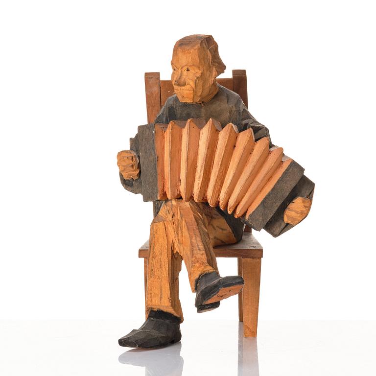 Axel Petersson Döderhultarn, Seated accordionist.