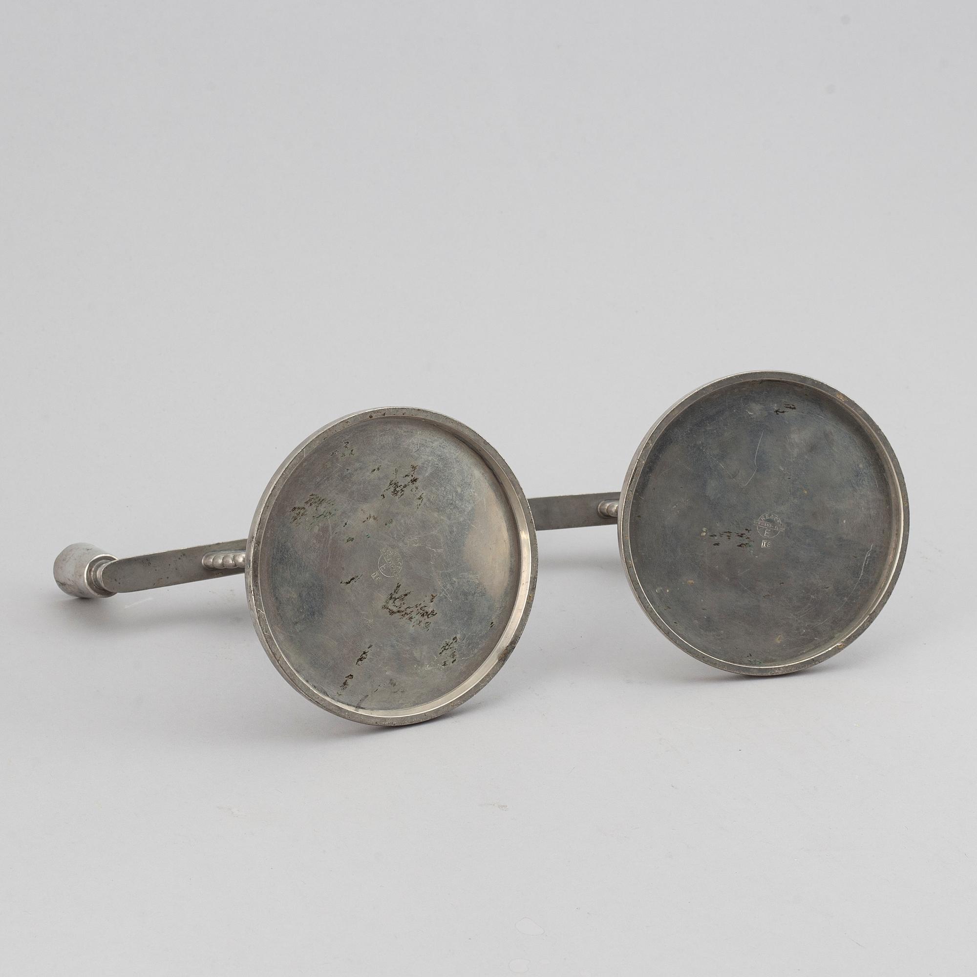 A pair of 1935 pewter candelabras by K E & Co.