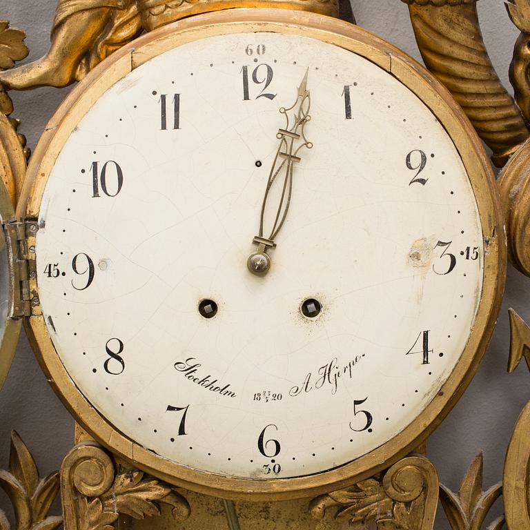 An empire gilt bronze wall clock by Anders Hjerpe, Stockholm, 1820.