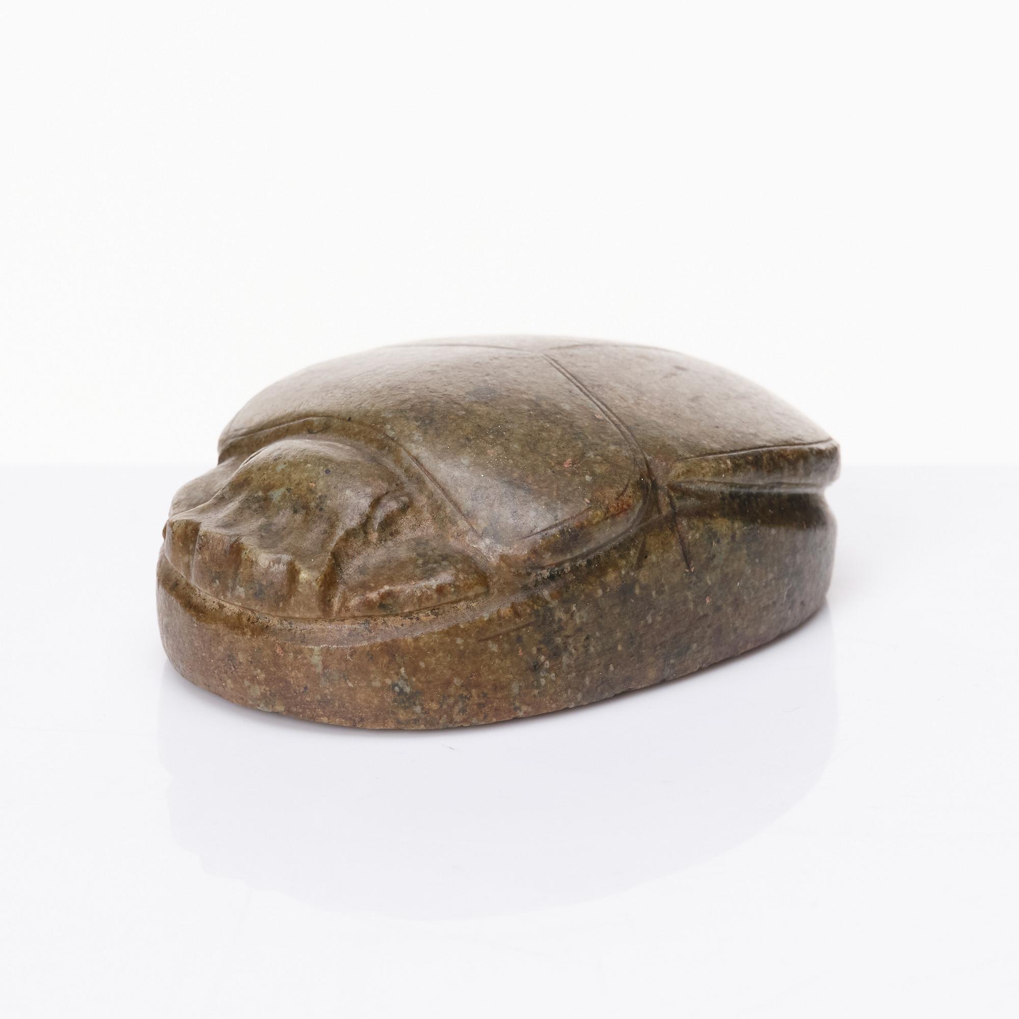 An Egyptian hardstone funerary scarab, probably Late Period, 26th-30th Dynasties, circa 664-343 B.C.