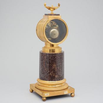 A Swedish Empire 19th century porphyry and gilt bronze mantel clock.