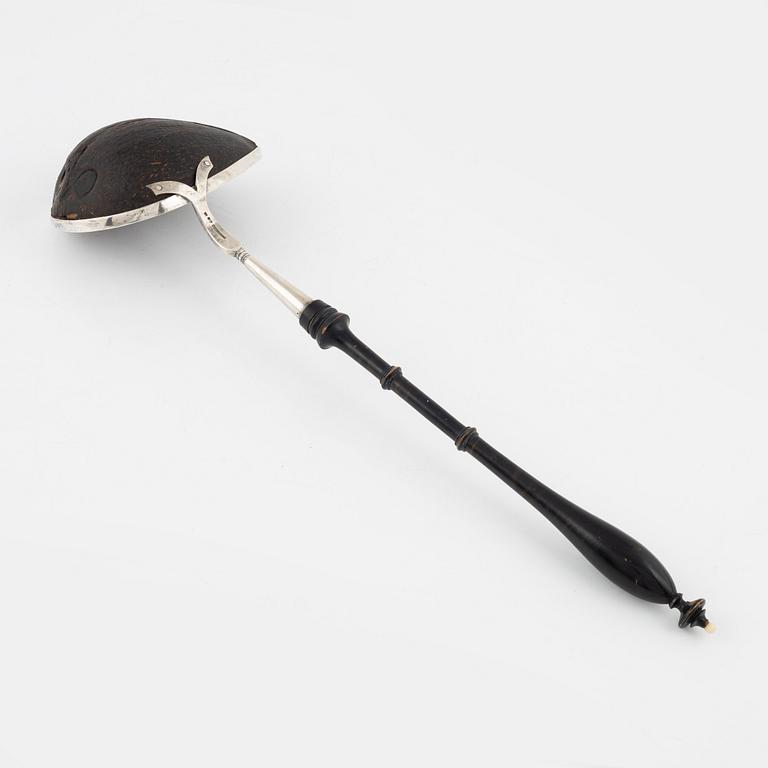 A silver mounted soup ladle with a coconut cup.