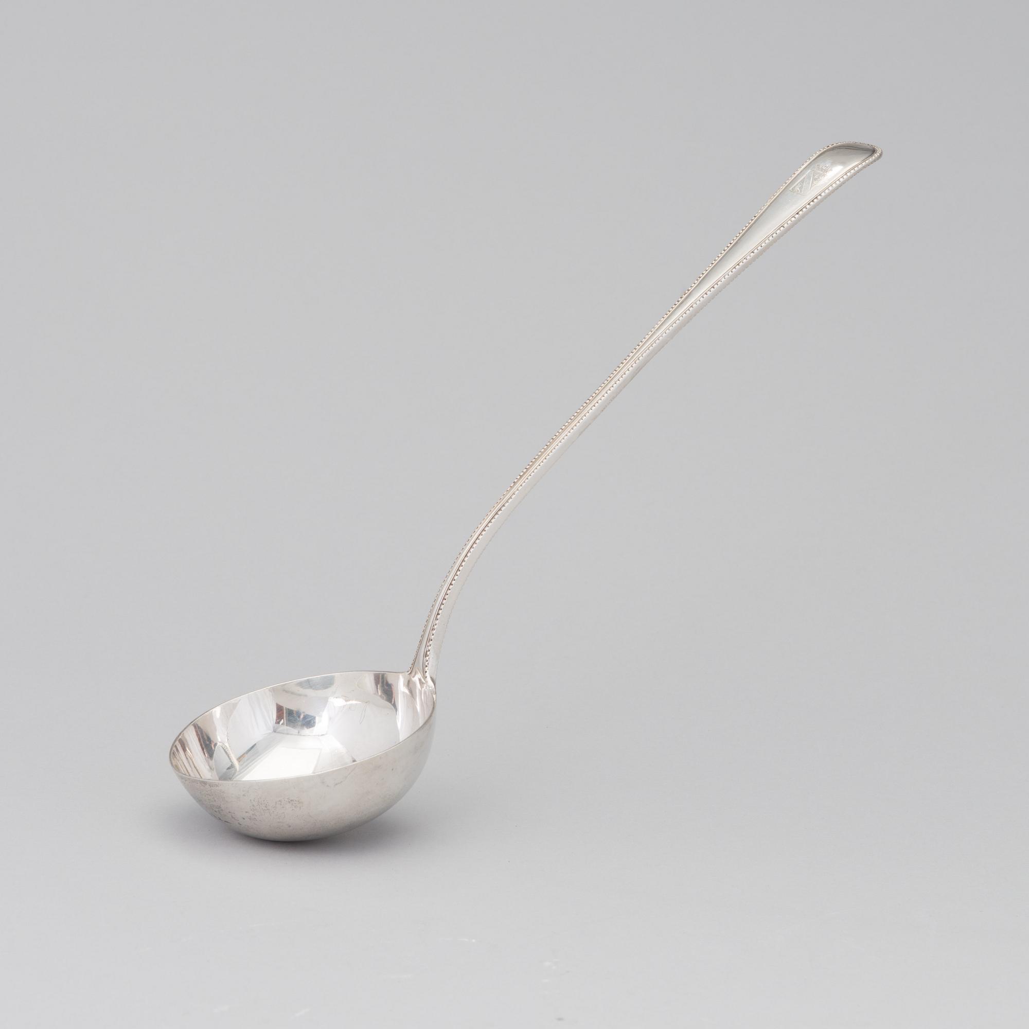 A soup ladle in sterling silver, mark of George William Adams, London 1867.