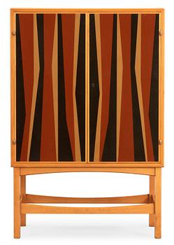 23. A Curt Blomberg mahogany cabinet, the doors, sides and top with painted panels, ca 1954.