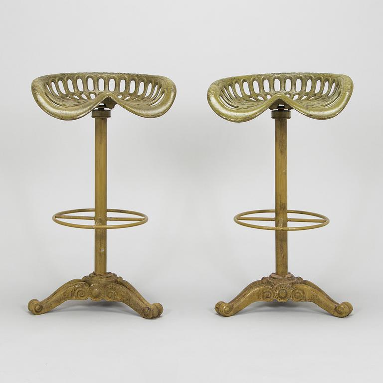 Four bar stools, painted cast iron, partly from the early 20th century.