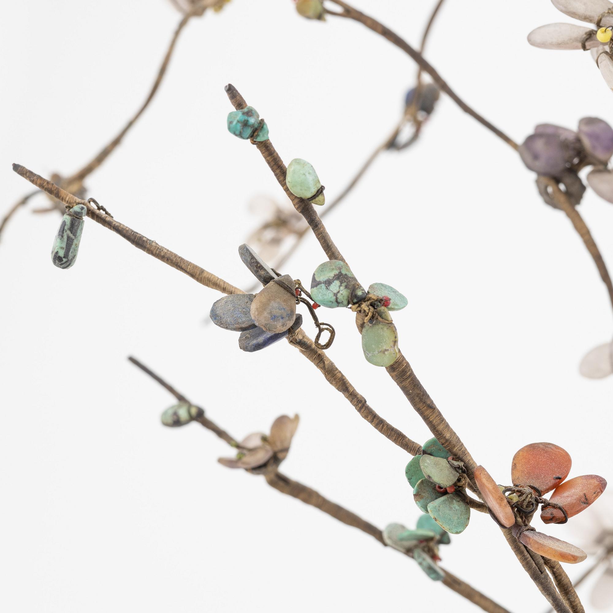 A decorative sculpture of a tree, made from nephrite, quartz, turkoise and lapis lazuli. China, 20th Century.