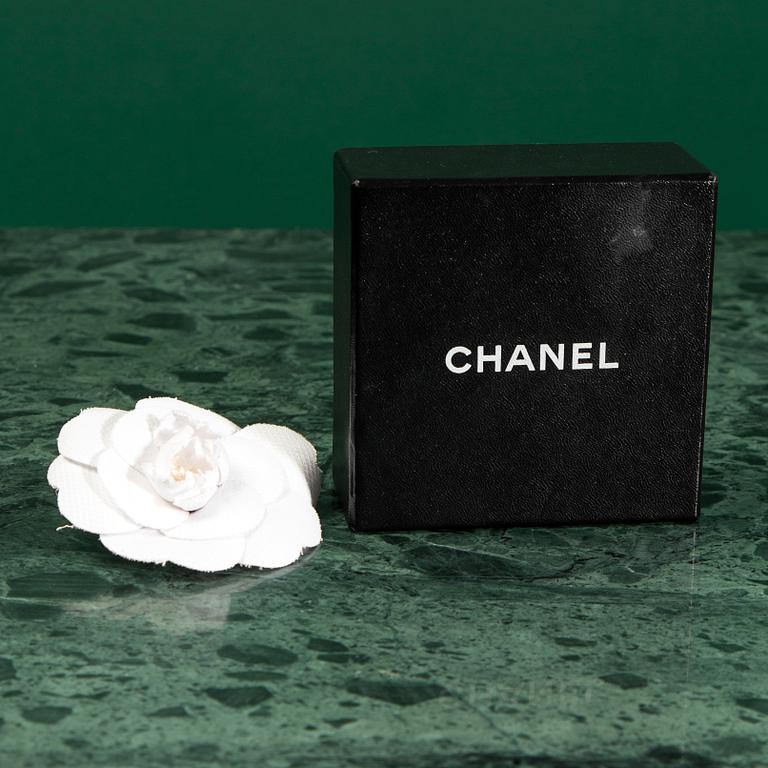 A Brooch by CHANEL.