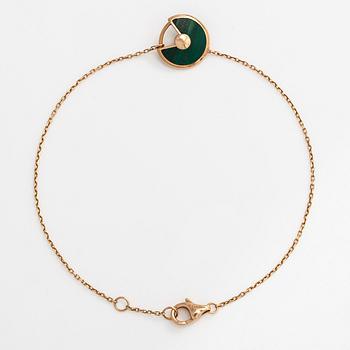 Cartier, an 18K gold "Amulette de Cartier" bracelet with malachite and a brilliant-cut diamond.