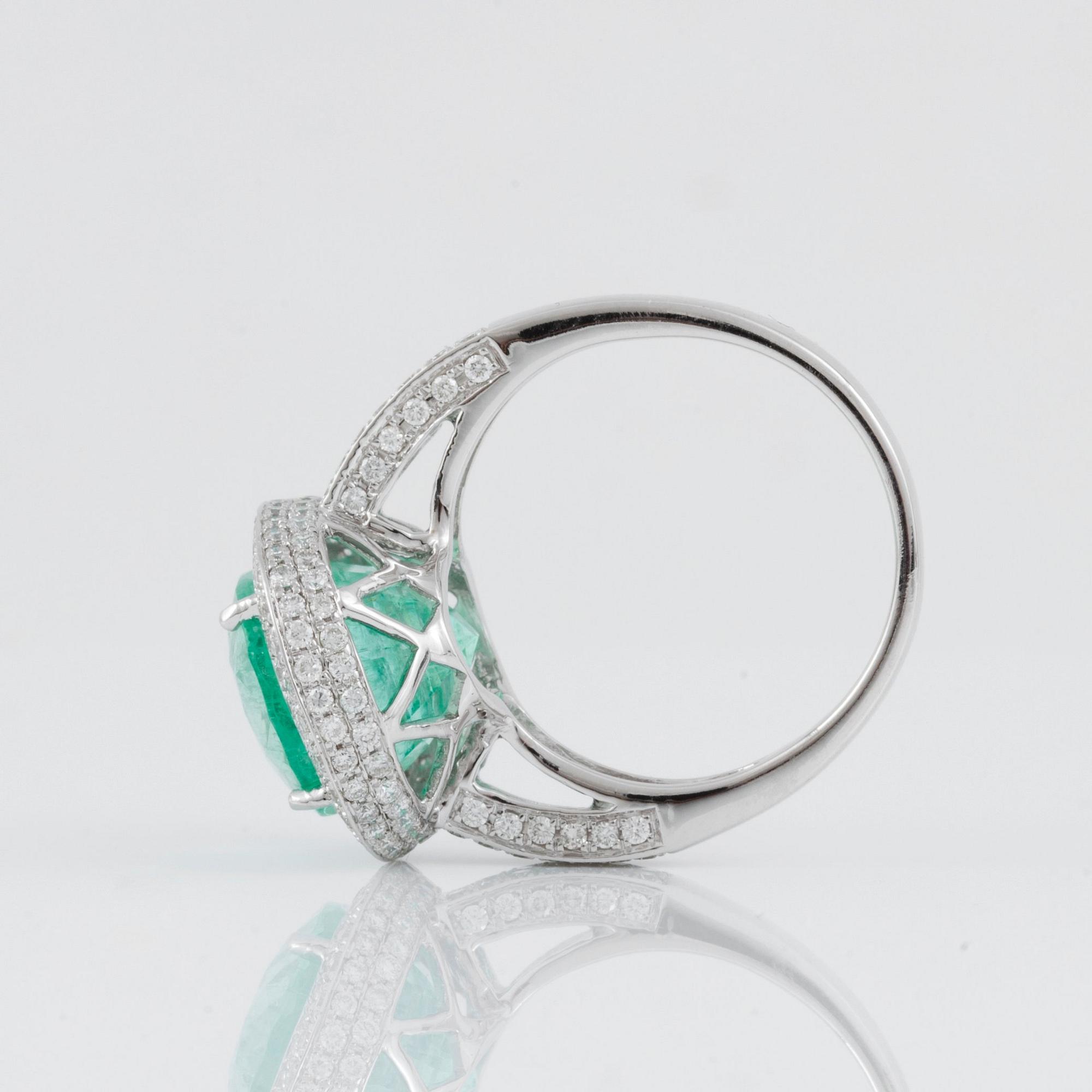 A green beryl, circa 6.00 cts, and diamond, circa 1.30 cts, ring.