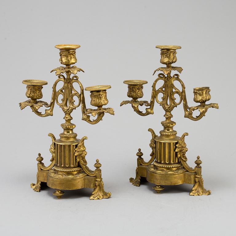 A table CLOCK and a pair of candelabra, second part of 19th century.