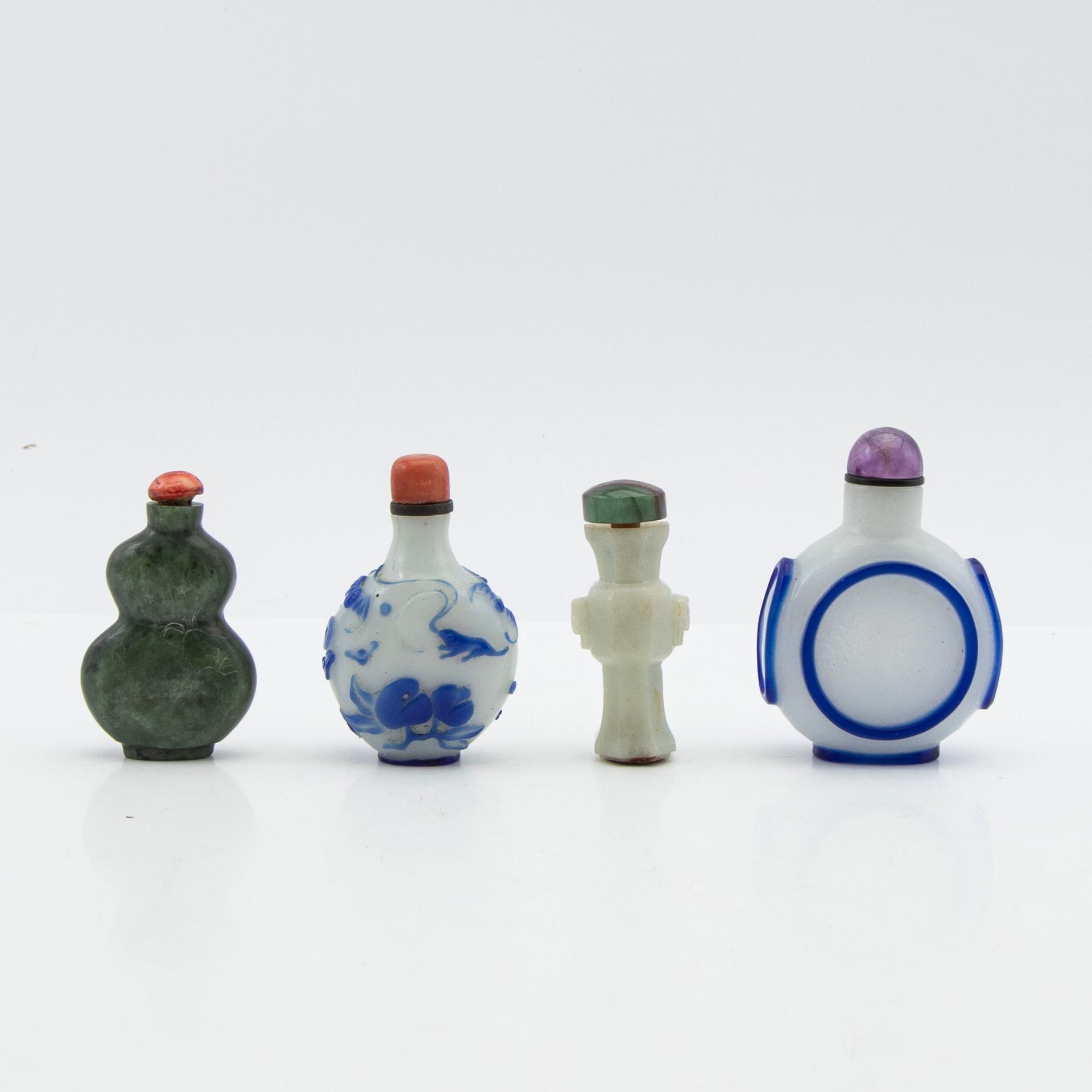 Snuff bottles, four pieces of Peking glass and stone. China, 20th century.