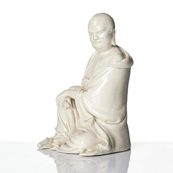 A blanc de Chine seated figure of Bodhidharma, Qing dynasty.