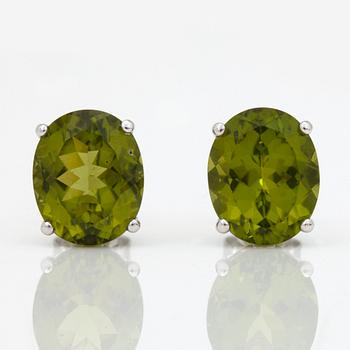 A pair of peridot and yellow cultured south sea pearl earrings.