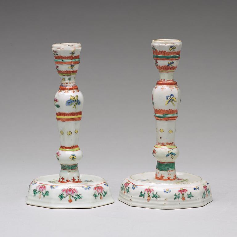 A pair of famille rose candle sticks, Qing dynasty, Qianlong (1736-95).