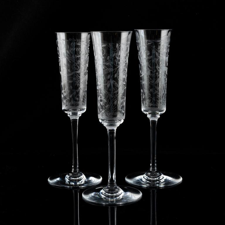 A set of 18 champagne flutes, engraved with animals and leafwork, 20th century Europe .