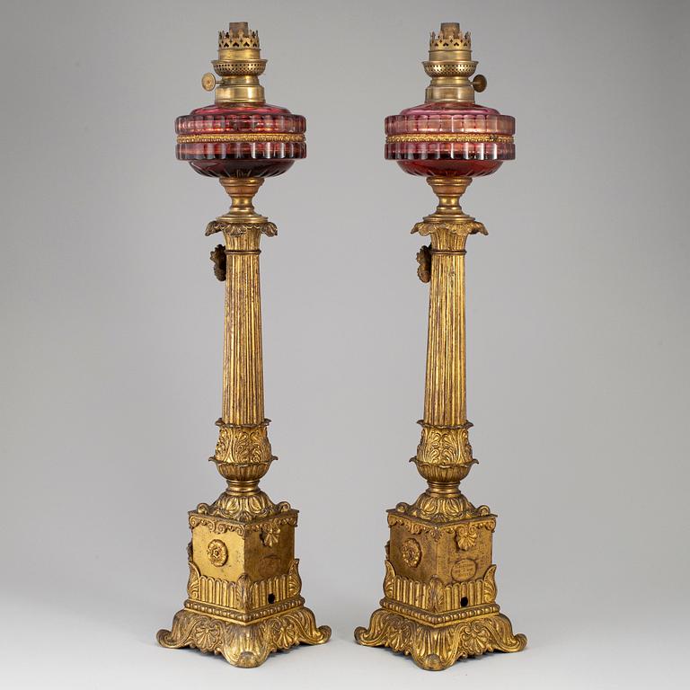 A pair of empire style table oil lamps, bronzed metal and glass, Dublot Freres, Rennes, late 19th century.