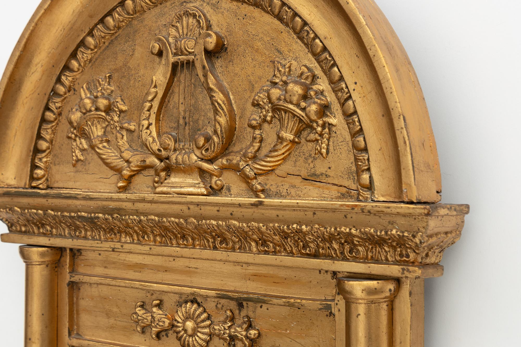 An Empire mirror, early 19th Century.