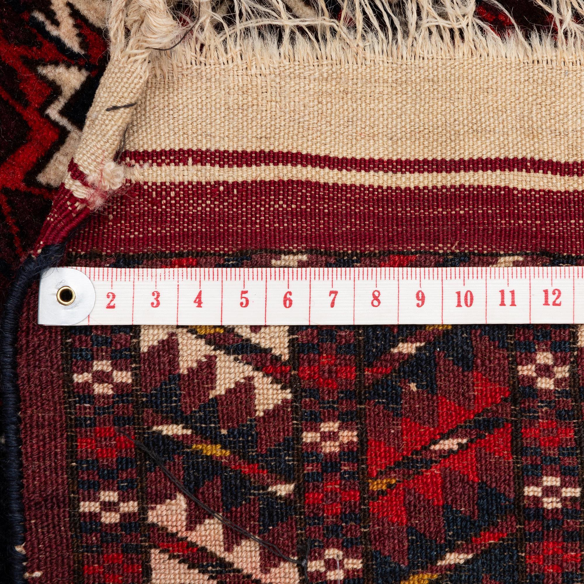 An antique Yomut rug, Western Turkmenistan, c. 119 x 104 cm.