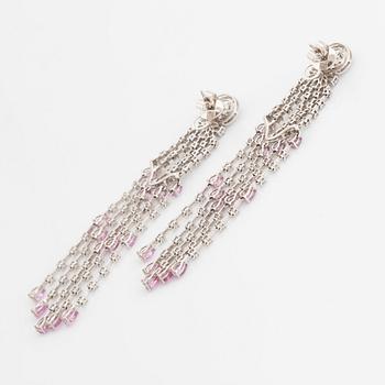 A pair of 18K white gold earrings set with faceted pink sapphires and round brilliant-cut diamonds.