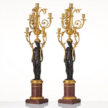 A pair of Louis XVI ormolu and patinated bronze six-branch candelabra attributed to François Rémond, late 18th century.